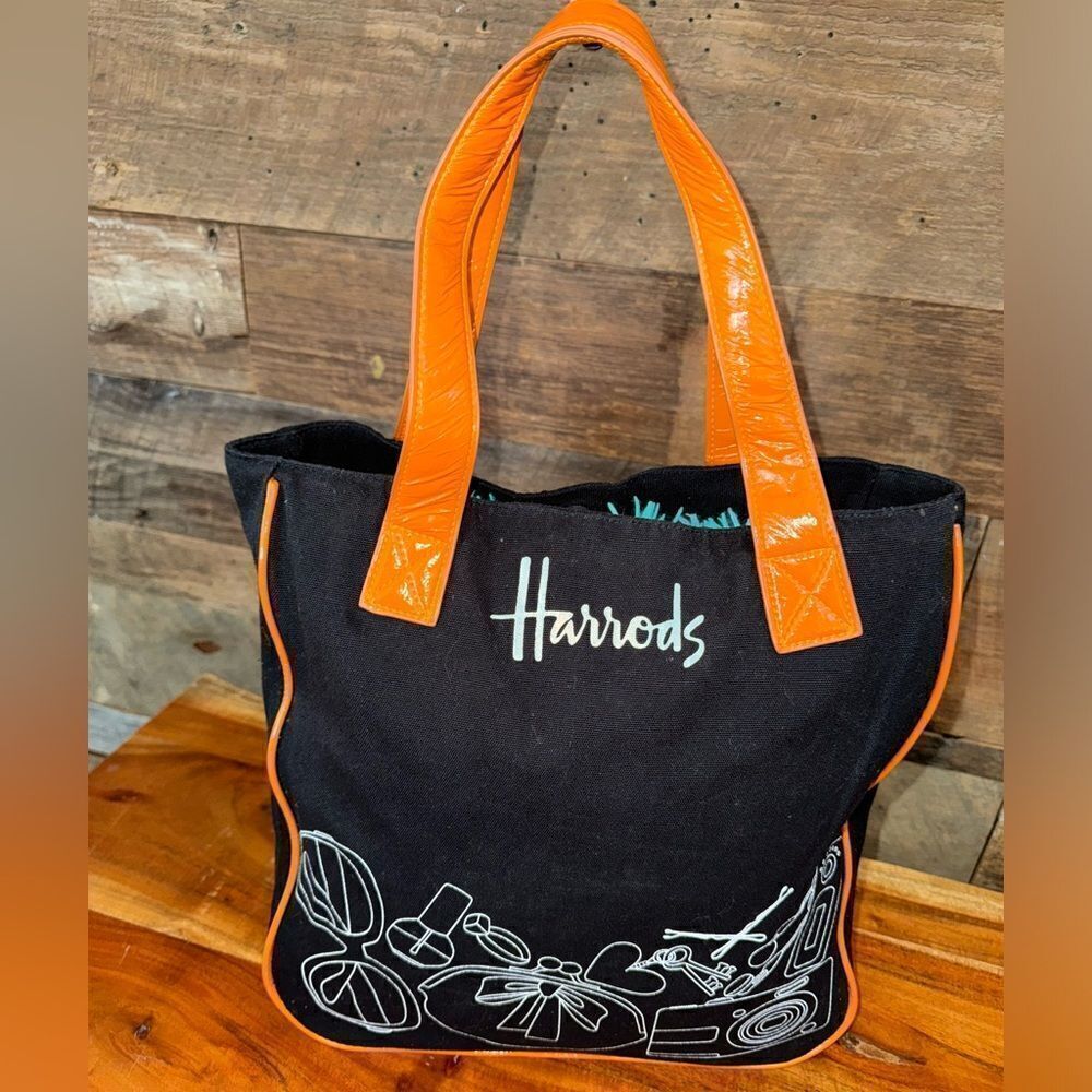 Harrods black canvas tote with orange paten leather trim and handles snap close